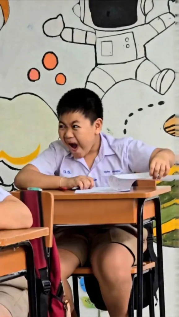  Wide angle shot of a classroom in Thailand with students intently focused on solving complex math problems