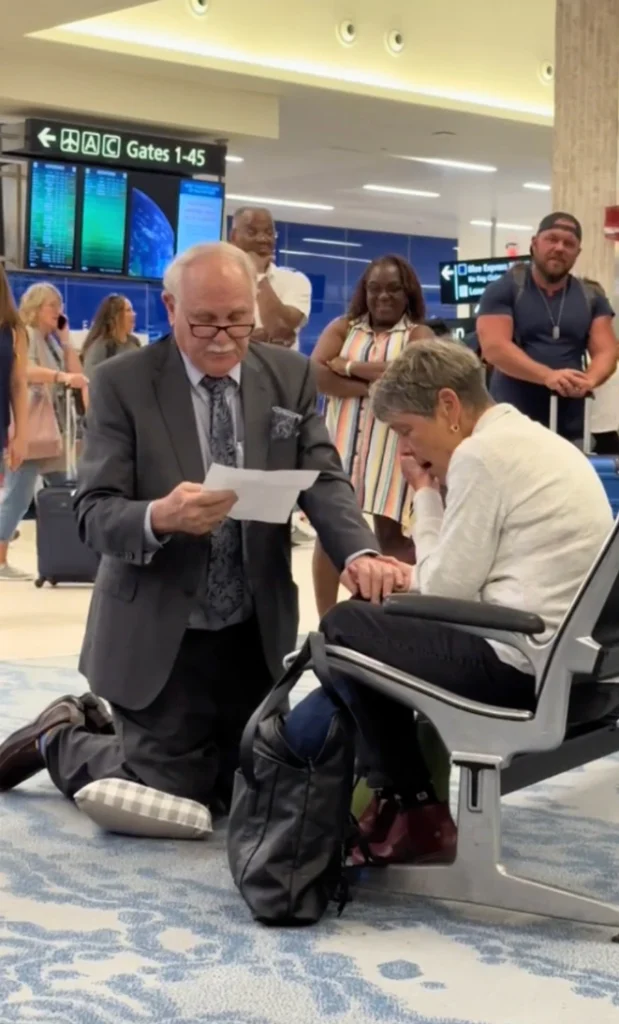 "78-year-old man proposes to his high school crush at the airport with flowers and a ring."