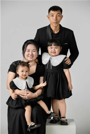 "Young Vietnamese parents holding hands with their son, symbolizing family unity"