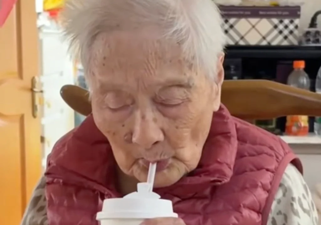 Happy 100-year-old woman smiling healthy aging lifestyle portrait