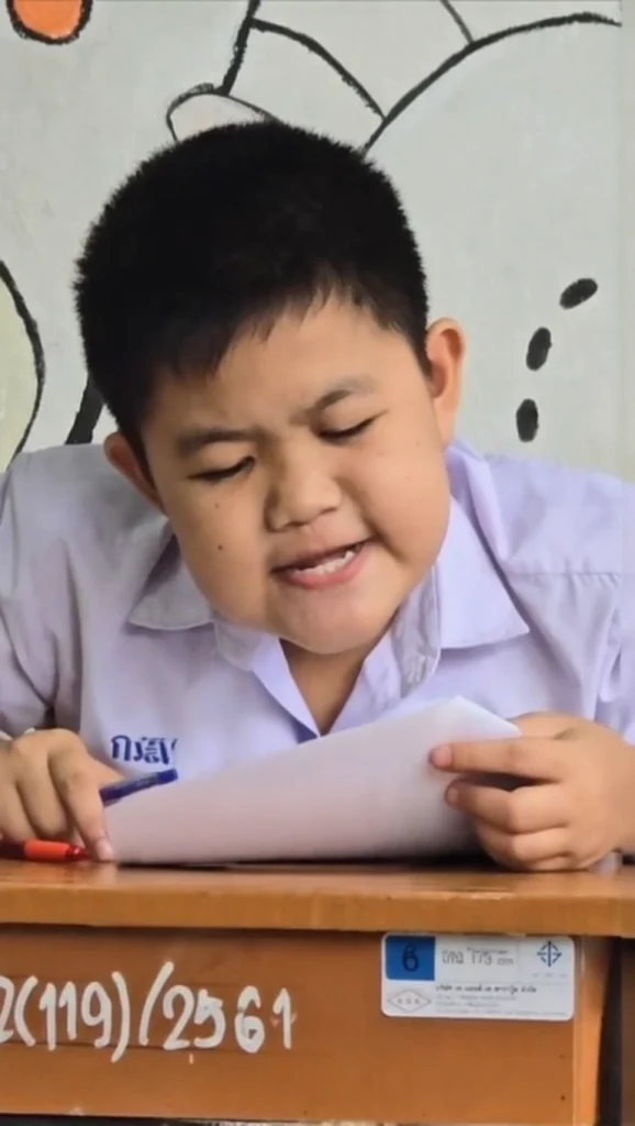 A student looking confused and stressed while reading the questions on a difficult math exam paper.