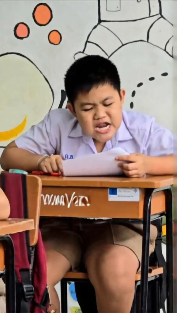 Viral TikTok screenshot of a Thai teacher smiling while students struggle with a math midterm exam in the background