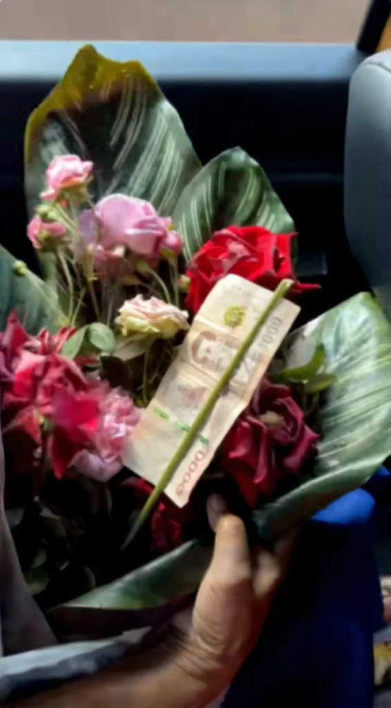 Close-up of fresh, home-grown flowers being carefully prepared and wrapped by a grandmother as a graduation gift.